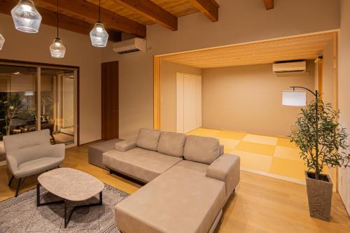 a living room with a couch and a chair at AWAUMI　富士・河口湖リゾート in Fujikawaguchiko