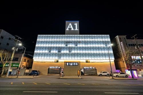 a lit up building with aaa sign on top of it at Pohang A1Hotel Haedo in Pohang