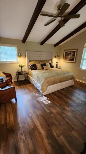 a bedroom with a bed and a ceiling fan at Wolf Creek Lodge in Atlanta