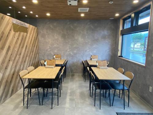 a dining room with wooden tables and chairs at The Toya in Lake Toya