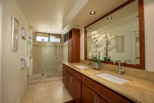 a bathroom with two sinks and a shower at Wailea Grand Champions Villas - CoralTree Residence Collection in Wailea