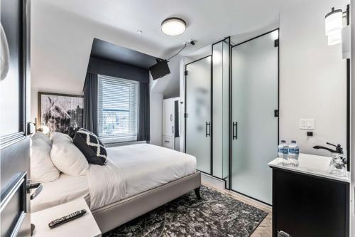 a bedroom with a large bed and a bathroom at The Inn on Officers' Garden in Calgary
