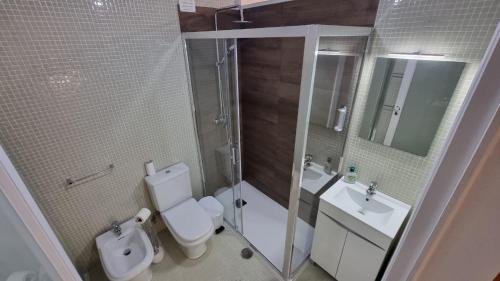 a bathroom with a toilet and a sink and a shower at Casa Sonho Azores - AL 1449 in Ponta Delgada
