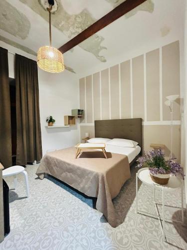 a bedroom with a bed and a table and chairs at Casa la cava in Taranto
