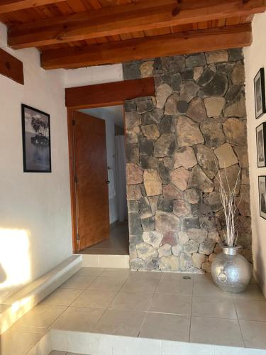a room with a stone wall and a door at La casa de las luciérnagas in Godínez