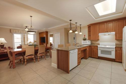 a large kitchen with a table and a dining room at Kay's Sweet Suite Near Disney in Orlando