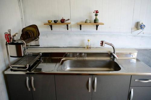 a kitchen with a stainless steel sink and a counter at Damyang Flower & Hanok in Damyang