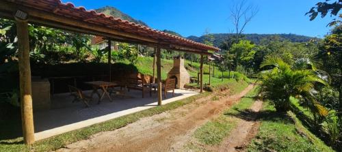 a patio of a house with a table at Serra Mar à beira rio , rafting, suites, lofts, e Casas in Casimiro de Abreu