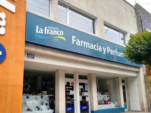 a store with a sign on the side of a building at Del Cerro Departamentos x 4 in El Calafate