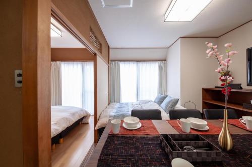 a living room with a bed and a table in a room at Second kuwamura building in Tokyo