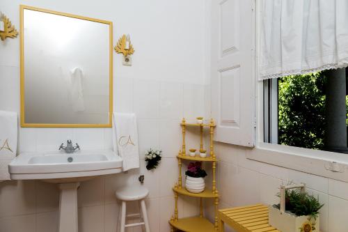 a bathroom with a sink and a window at Casa da Azenha in Peso da Régua