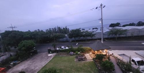 an aerial view of a house with a yard at Jeju Soroan Pension in Seogwipo