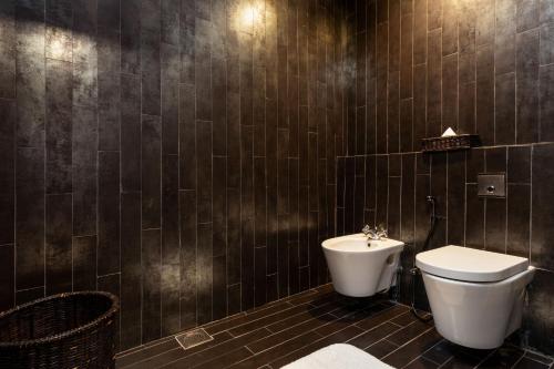 a bathroom with a toilet and a sink at Jetwing Lighthouse, A Luxury Reserve in Galle