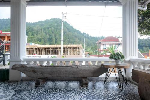 a large stone tub in a room with a large window at RedDoorz near Grojogan Sewu Tawangmangu in Karanganyar
