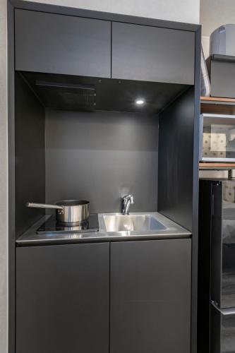 a kitchen with a sink and a stove at Serendipity Kinshicho in Tokyo