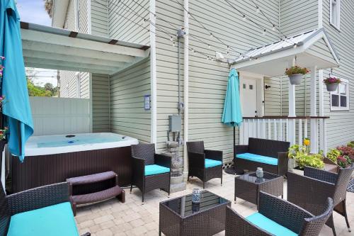a patio with a hot tub and tables and chairs at Hot tub- 80's Arcade- Pool table- Historic Downtown- 7 car parking in St. Augustine