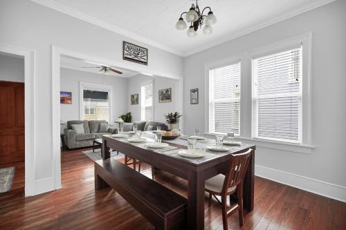 a dining room with a table and a living room at Hot tub- 80's Arcade- Pool table- Historic Downtown- 7 car parking in St. Augustine