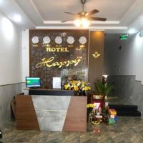 a hotel lobby with a reception desk and a ceiling fan at Happy 2 Hotel Bình Dương in Bến Cát