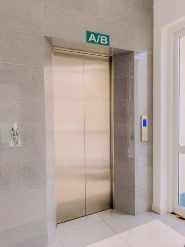 a elevator in a building with a sign on it at MaSa Beach Front Apartment Uswetakeiyawa B12 in Ja-Ela