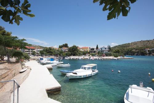 a group of boats docked in a body of water at Apartments with parking space Zaboric, Sibenik - 21367 in Zaboric