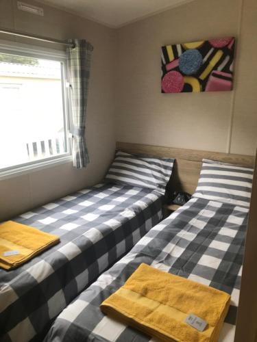 two beds sitting next to each other in a room at Static stays in Longridge