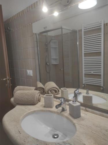 a bathroom with a sink and a large mirror at Villa Adele in Torre Santa Sabina