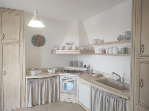a kitchen with a sink and a stove at Villa Adele in Torre Santa Sabina