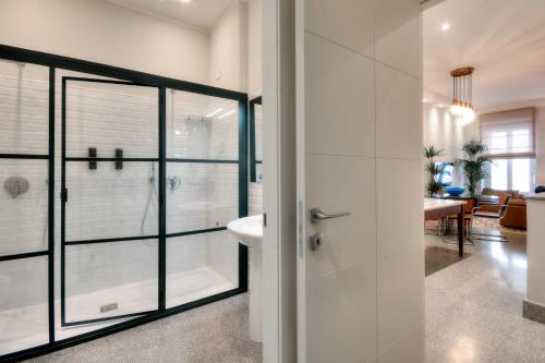 a bathroom with a glass shower and a sink at Right House - Indipendent in Characteristic Marina District in Cagliari