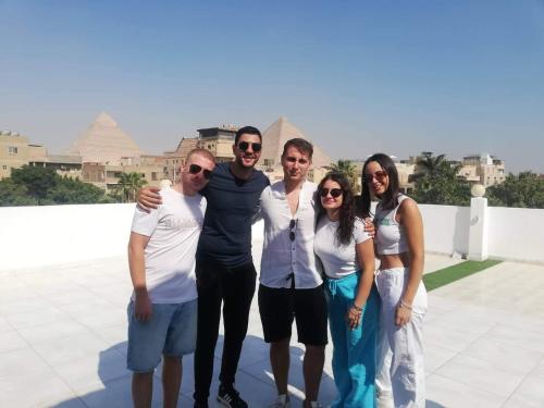 a group of people posing for a picture on a roof at Matto Pyramids Inn in Cairo