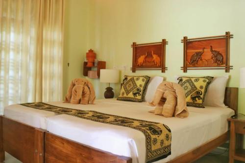 a bedroom with a bed with stuffed animals on it at Villa Svara in Kosgoda