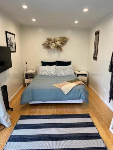 a bedroom with a bed and two night stands at Central Matamata Boutique in Matamata