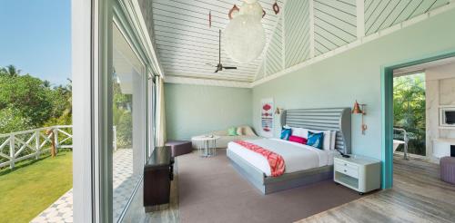 a bedroom with a bed and a balcony at W Goa in Vagator