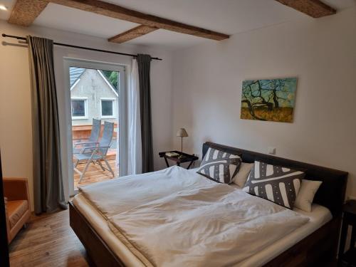 a bedroom with a bed and a sliding glass door at FeWo Monika in Schaprode