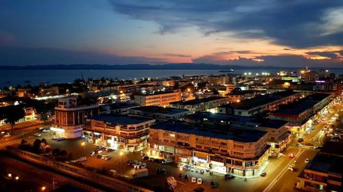 a city lit up at night with a city at LA Hotel in Tawau