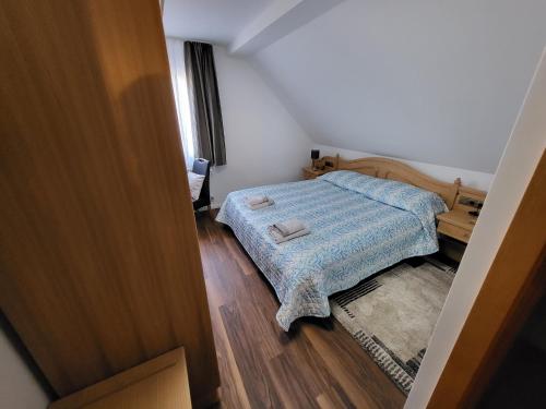 a small bedroom with a bed and a desk at Bergischer Hof - Bergischer Hofgarten in Windeck