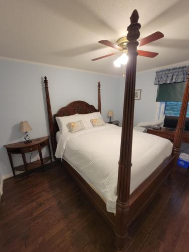 a bedroom with a bed with a ceiling fan at Bluejay Suites B&B in Whitehorse