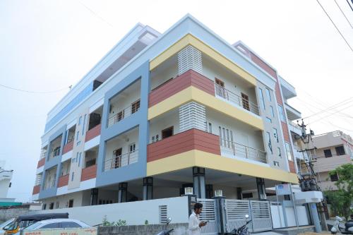 a man walks in front of a building at Padma Homes Stay- Luxury Service Apartment 1BHK & 2BHK & 3BHK in Tirupati
