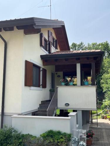a white house with stairs and a balcony at Casa vacanze a Prosecco - Trieste in Trieste