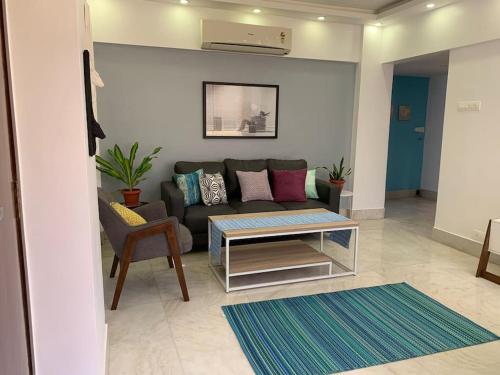 a living room with a couch and a table at Mon Desire 1, Perry Cross Rd, Bandra West by Connekt Homes in Mumbai