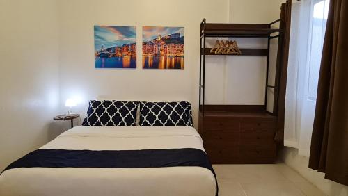 a bedroom with a bed in a room with a poster at NuGen Suites Staycations in Manila