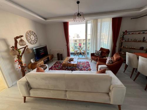 a living room with a white couch and a table at Mersin'in en lüks ve en güzel 2+1 evi in Mersin