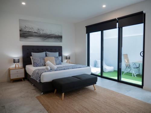 a bedroom with a bed and a large window at Karma Villas in Gold Coast