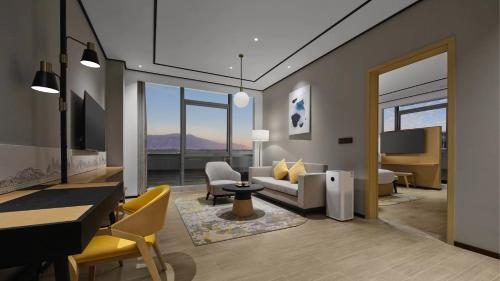a living room with a couch and a table at Hilton Garden Inn Beijing Haidian Daoxiang Lake in Beijing