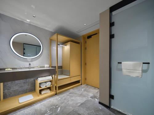 a bathroom with a sink and a mirror at Hilton Garden Inn Huzhou Anji Phoenix Mountain in Anji