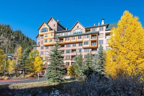 a large building on a hill with trees at Ski-In/Ski-Out Zephyr 1 Bedroom Condo Winter Park in Winter Park