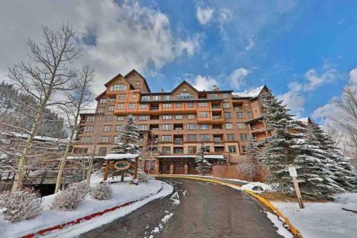 a large building on a snow covered road at Ski-In/Ski-Out Zephyr 1 Bedroom Condo Winter Park in Winter Park