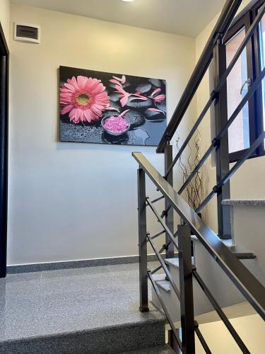 a painting of a pink flower on a wall at Bóris House in Ognyanovo
