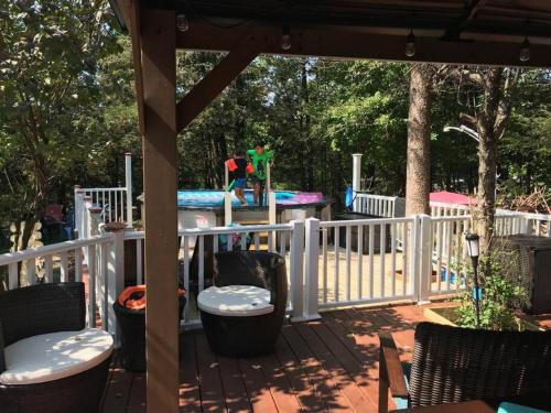 a porch with a play park with a playground at 3 Acre Lake Paradise Swimming Pool & Jacuzzi HotTub! in Hopatcong