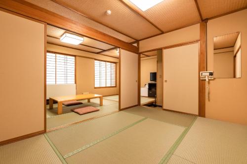 an empty room with a table and a tablektop at Ooedo Onsen Monogatari Kounkaku in Osaki