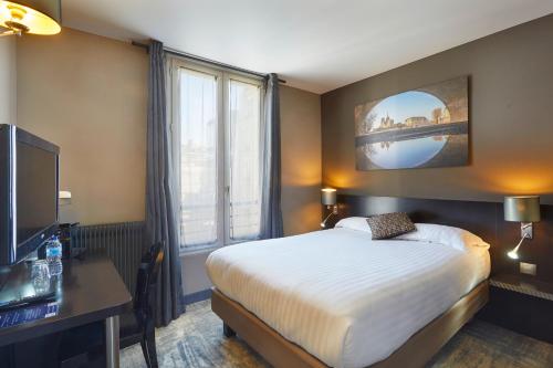 a bedroom with a bed and a large window at Logis h&ocirc;tel Jardin de Villiers in Paris